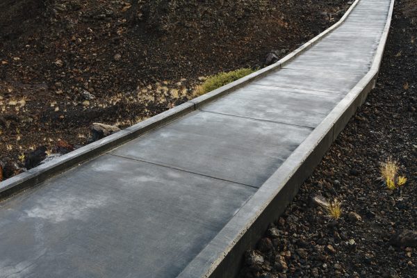 A paved pathway up into the lava fields of the Craters of the Moon national monument and preserve in Butte County Idaho.
